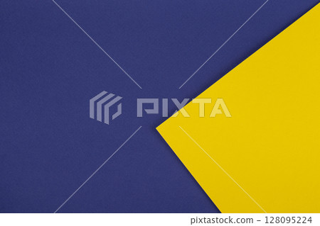 Paper blue background with yellow triangle. Colored paper geometric shapes with blue and yellow tones. 128095224