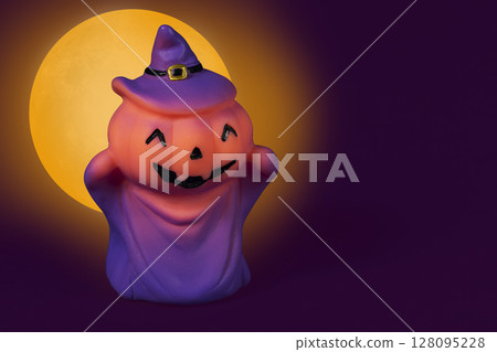 Halloween pumpkin doll on a yellow moon background. Halloween pumpkin doll on a yellow moon background. 128095228