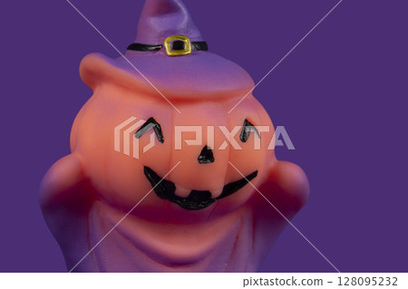 Halloween pumpkin witch doll on purple background. Halloween pumpkin witch doll on purple background. 128095232