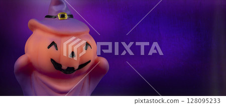 Halloween pumpkin witch doll on purple background. Halloween pumpkin witch doll on purple background. 128095233