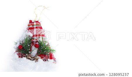 Christmas background. Christmas toy santa claus hat in the snow. 128095237