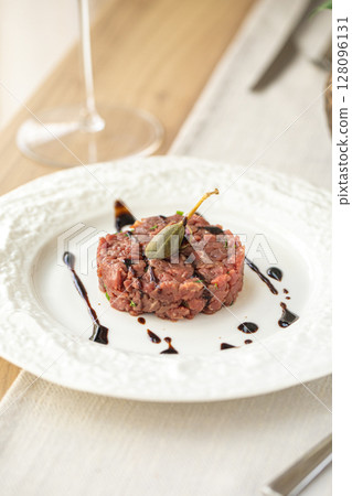Beef tartare with caper and balsamic on plate Beef tartare with caper and balsamic on plate 128096131