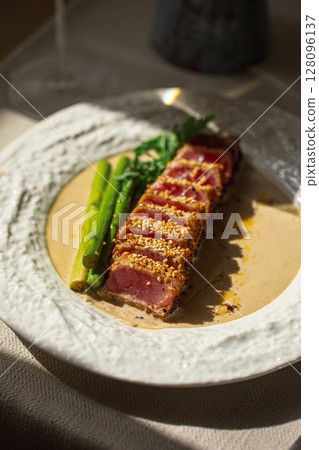 Grilled sliced tuna with asparagus and sesame Grilled sliced tuna with asparagus and sesame 128096137