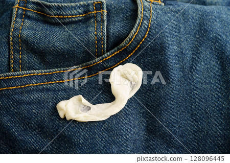 Dirty chewing gum stain removal on cloth jean accident to wash with washing powder, cleaning housework. 128096445