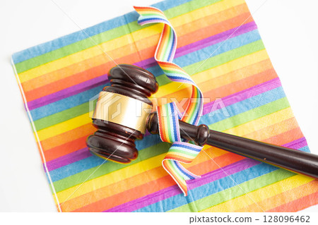 Gavel for judge lawyer on rainbow flag, symbol of LGBT pride month. Gavel for judge lawyer on rainbow flag, symbol of LGBT pride month. 128096462