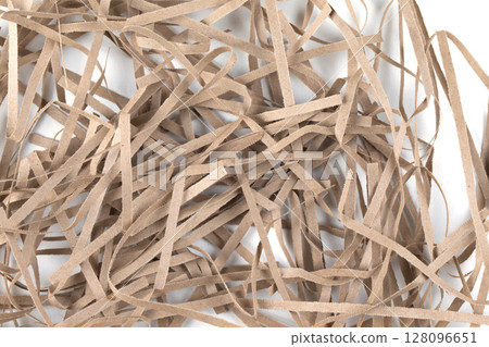 Torn paper strips close-up. A bunch of shredded cardboard. Torn paper strips close-up. A bunch of shredded cardboard. 128096651