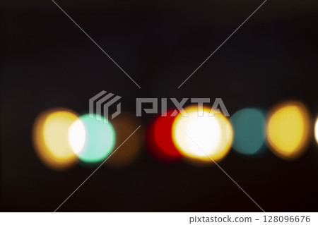 Stripe of multicolored bokeh spots on a black background. 128096676