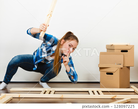 Woman assembling wooden furniture. DIY. Woman assembling wooden furniture. DIY. 128097225