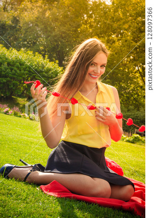 Young happy woman with hearts Young happy woman with hearts 128097366