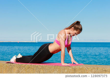 Young woman exercising outside 128097373