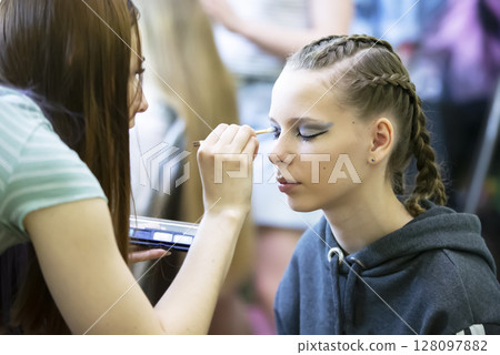 Makeup artist does makeup to the girl. Makeup artist does makeup to the girl. 128097882