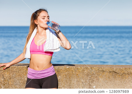 Woman drinking water after sport gym outdoor 128097989