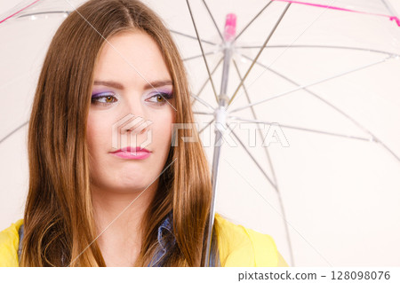 Woman under umbrella looking sad unhappy 128098076
