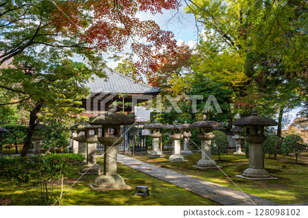 Historic Jigen-do temple garden with moss-covered stone lantern and tranquil autumn scenery. Shiga Prefecture, Otsu City, Sakamoto 128098102