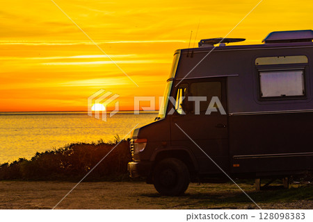Camper vehicle on beach at sunrise 128098383