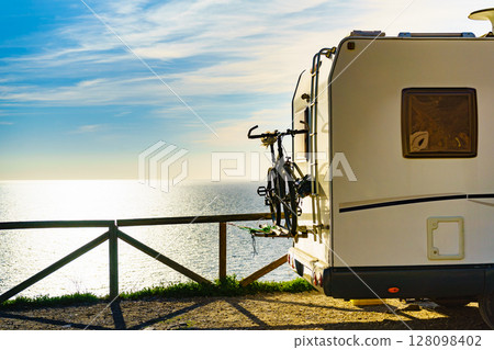 Camper van with bicycle on back rack. 128098402