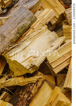 Stack of firewood on green grass. Stack of firewood on green grass. 128098410