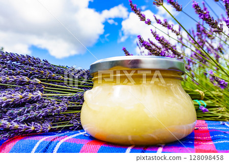 Jar with honey and lavender flowers. Jar with honey and lavender flowers. 128098458