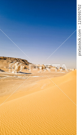 White rock formations and sand dunes in Egypt's White Desert, natural desert landscape White rock formations and sand dunes in Egypt's White Desert, natural desert landscape 128098702