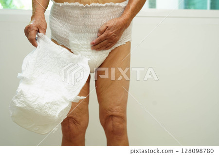 Asian senior woman patient wearing adult incontinence diaper pad in hospital. Asian senior woman patient wearing adult incontinence diaper pad in hospital. 128098780
