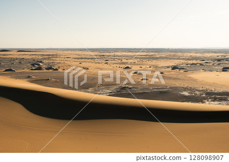 White rock formations and sand dunes in Egypt's White Desert, natural desert landscape White rock formations and sand dunes in Egypt's White Desert, natural desert landscape 128098907