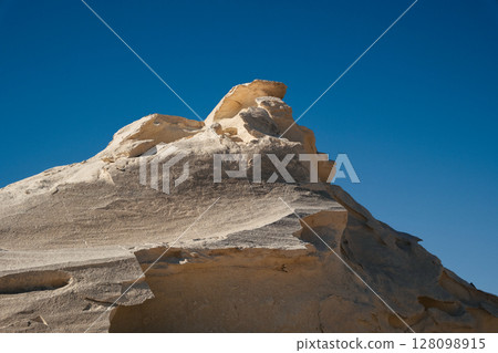White rock formations and sand dunes in Egypt's White Desert, natural desert landscape White rock formations and sand dunes in Egypt's White Desert, natural desert landscape 128098915