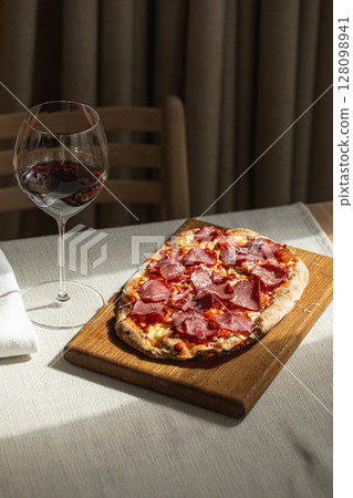 Pinsa with cured meat and cheese Pinsa with cured meat and cheese 128098941