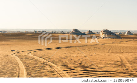 Tire mark on the sand after the car. Texture after car's wheel Tire mark on the sand after the car. Texture after car's wheel 128099074