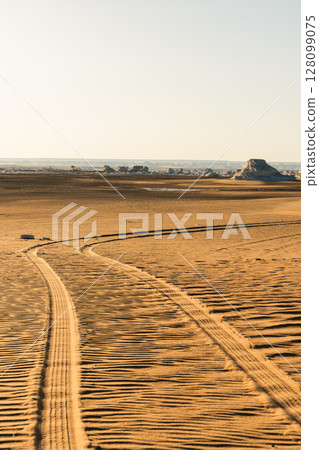 Tire mark on the sand after the car. Texture after car's wheel 128099075