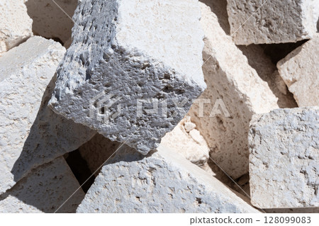 White concrete foundation blocks for construction, building materials and site preparation	 128099083