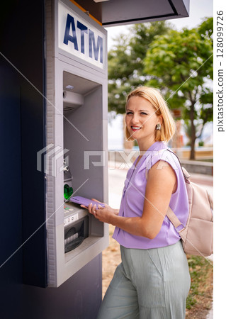 Summer moments at the ATM in Greece by the coast Summer moments at the ATM in Greece by the coast 128099726