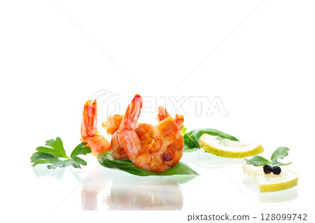Delicious sea shrimps with lemon isolated on white Delicious sea shrimps with lemon isolated on white 128099742