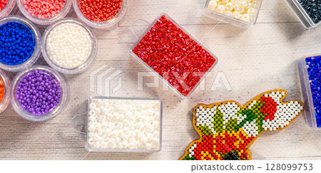 Colorful glass beads. Variety of shapes and colors to make a bead necklace or a string of beads for women 128099753