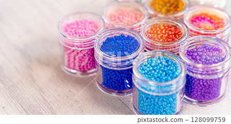 Colorful glass beads. Variety of shapes and colors to make a bead necklace or a string of beads for women 128099759