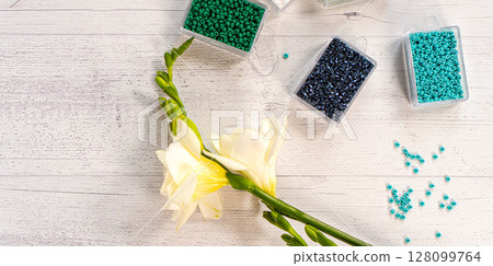 Colorful glass beads with flowers. Variety of shapes and colors to make a bead necklace or a string of beads for women Colorful glass beads with flowers. Variety of shapes and colors to make a bead necklace or a string of beads for women 128099764