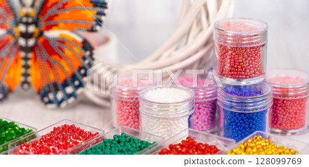 Colorful glass beads. Variety of shapes and colors to make a bead necklace or a string of beads for women 128099769