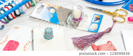 Accessories for hobbies. Needles, threads, hoops snaps, marker, stick for knitting and embroidery Accessories for hobbies. Needles, threads, hoops snaps, marker, stick for knitting and embroidery 128099836