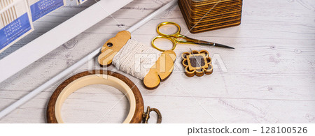 Accessories for hobby. Hoop snaps, threads, needles and scissors. Vintage tools for embroidery and knitting 128100526