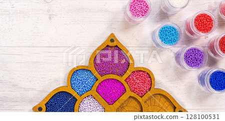 Colorful glass beads. Variety of shapes and colors to make a bead necklace or a string of beads for women 128100531