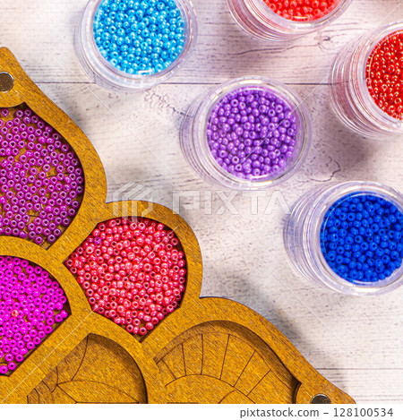 Colorful glass beads. Variety of shapes and colors to make a bead necklace or a string of beads for women 128100534