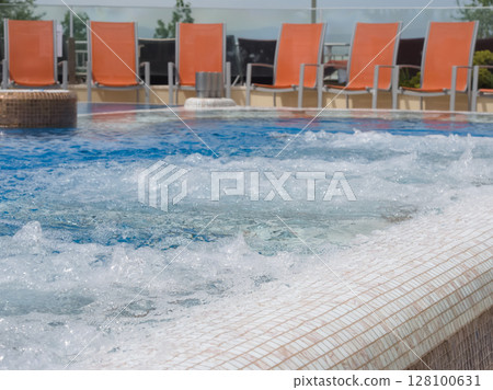 Bubbling Hot Tub with Lounge Chairs Bubbling Hot Tub with Lounge Chairs 128100631