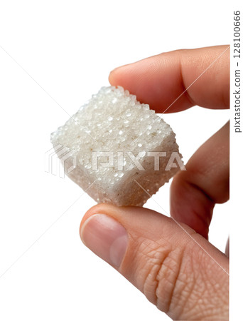Sugar cube held between fingers against transparent background, sweetener concept, coffee or tea additive, white refined sugar Sugar cube held between fingers against transparent background, sweetener concept, coffee or tea additive, white refined sugar 128100666