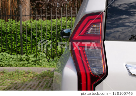 Back Light Of Vehicle Stay In Front Of Fence Of Forest Park Back Light Of Vehicle Stay In Front Of Fence Of Forest Park 128100746