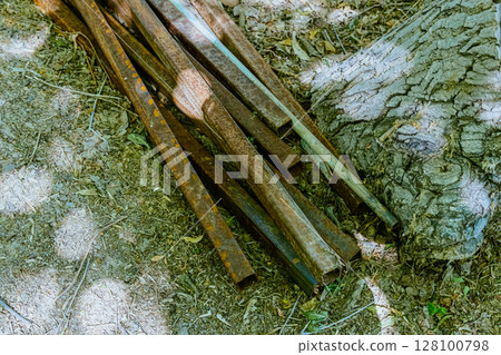 Steel rods bars, Metal, and Iron reinforcement lying on the ground on the construction site for material used for reinforcing concrete building construction. Concept background textured architecture 128100798