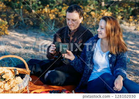 Portrait happy beautiful couple in love enjoying autumn picnic in autumn park. High quality photo Portrait happy beautiful couple in love enjoying autumn picnic in autumn park. High quality photo 128102030