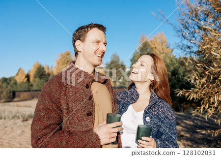 Happy beautiful couple in love enjoying autumn picnic in park. Weekend and lifestyle concept. High quality photo Happy beautiful couple in love enjoying autumn picnic in park. Weekend and lifestyle concept. High quality photo 128102031