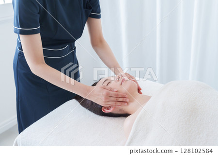 A woman attending a beauty salon A woman attending a beauty salon 128102584