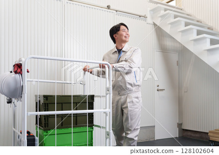 Male worker working in a warehouse Male worker working in a warehouse 128102604