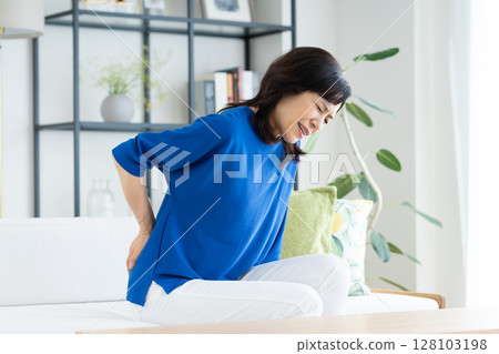 Middle-aged woman with back pain 128103198