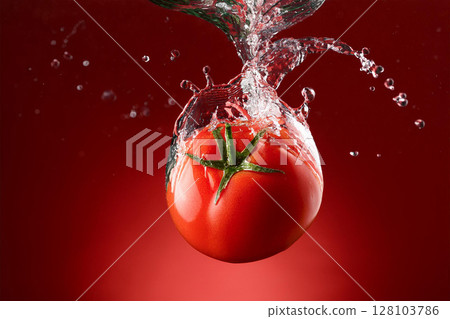 Tomatoes falling into the water 128103786